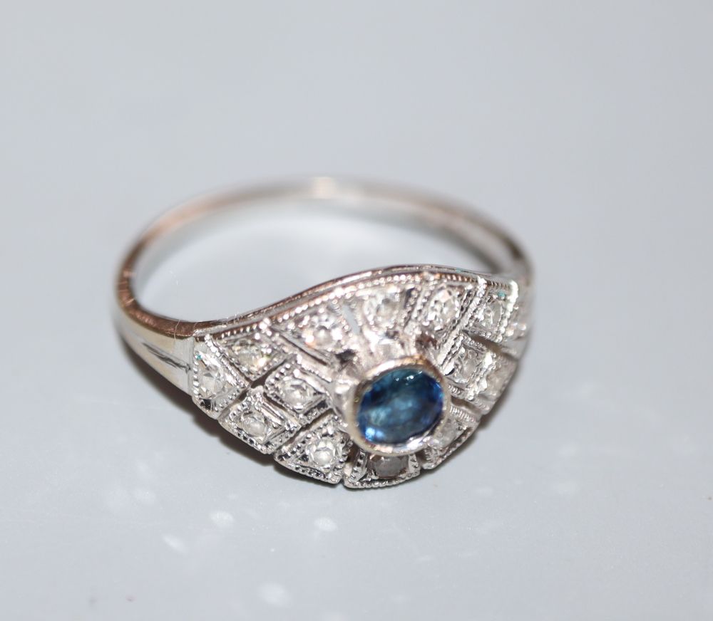 A pierced 18ct white metal, sapphire and diamond cluster dress ring, size G, gross 2.1 grams.